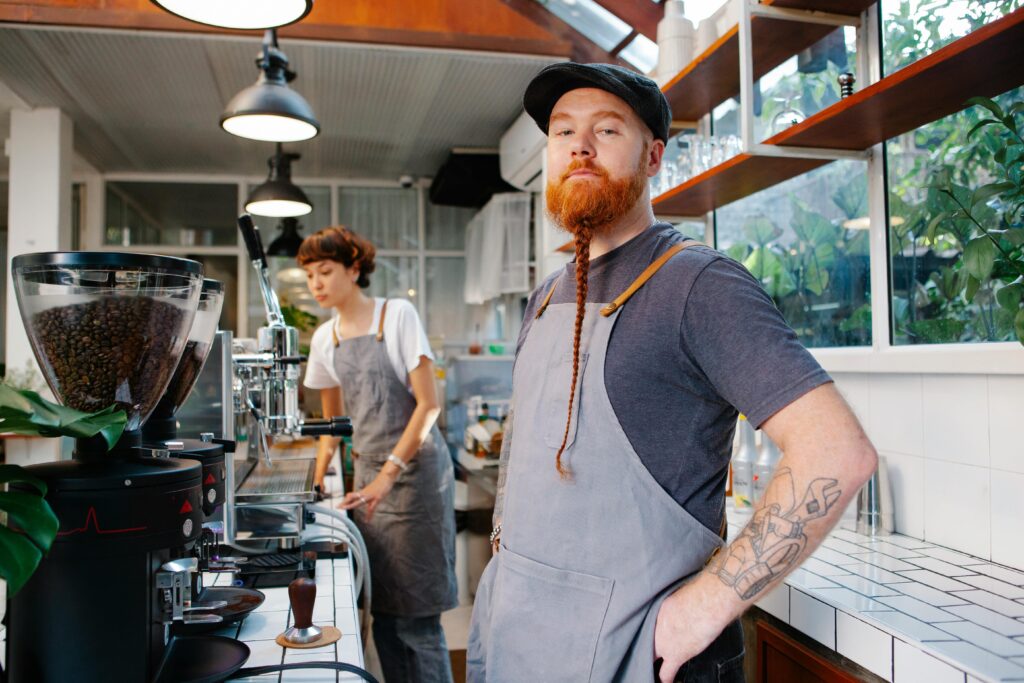 pexels-photo-6205639-6205639 Barista team working with coffee equipment in a stylish, light-filled café. Focused on brewing excellence.